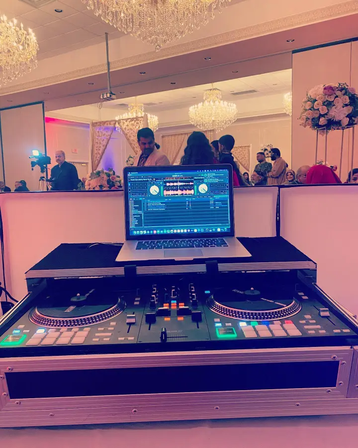 DJ booth with pink uplighting