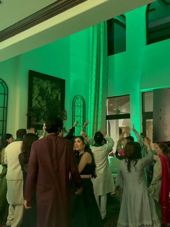 Packed dance floor under green uplighting